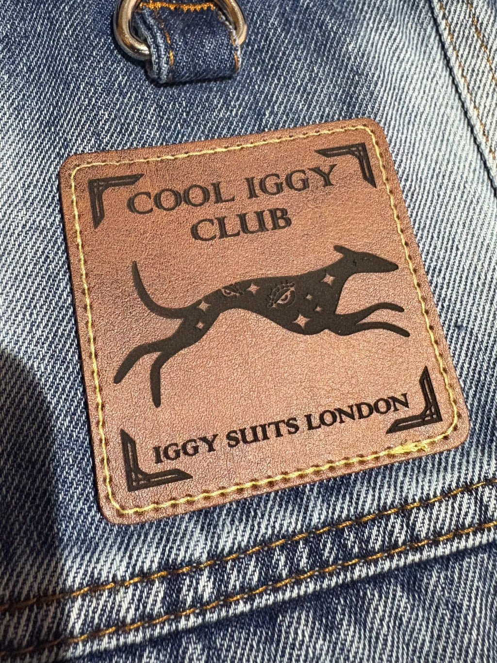 Patch with 'Cool Iggy Club' and 'Iggy Suits London' text on a denim background