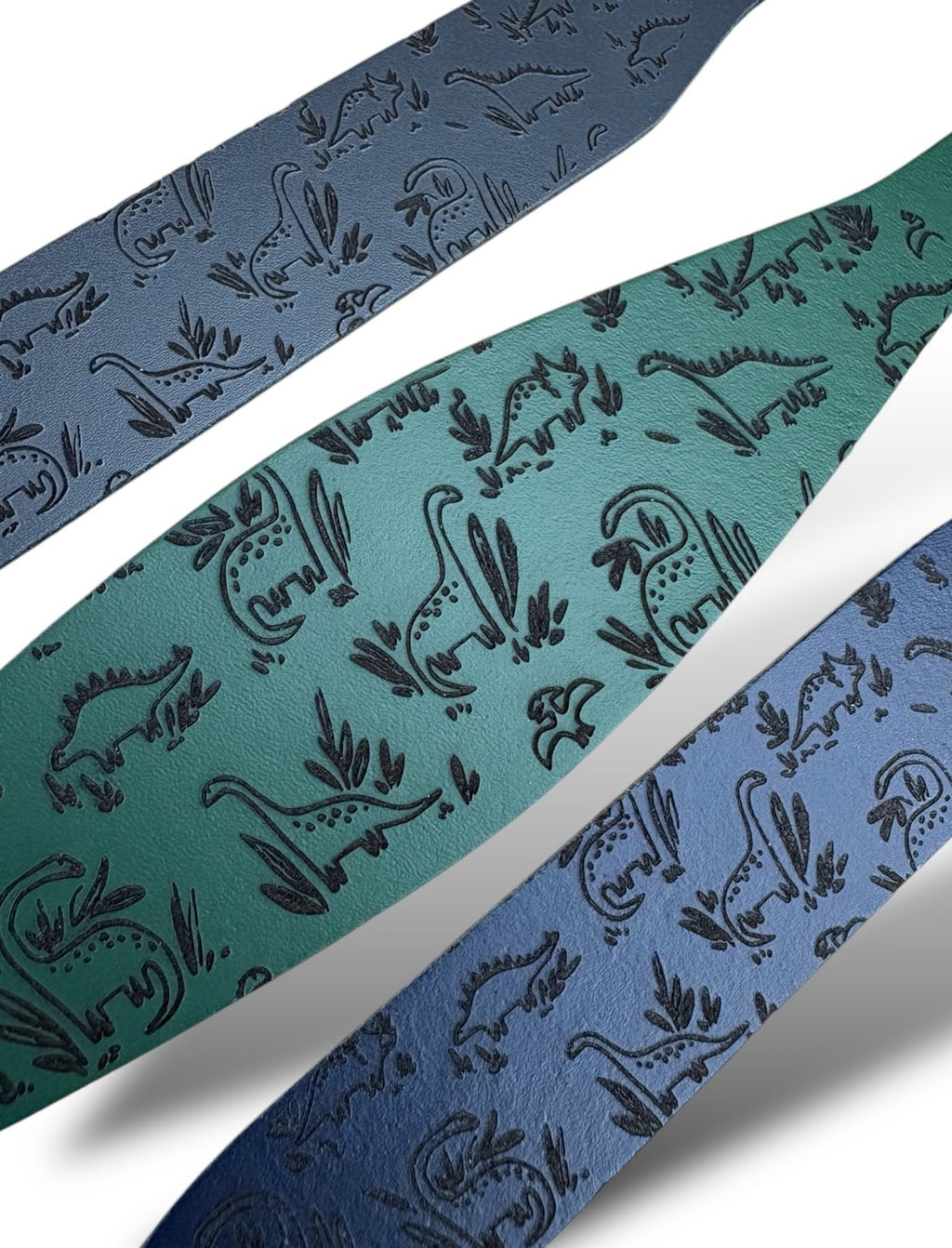 Three ribbons with dinosaur patterns in blue, green, and multicolor on a white background.