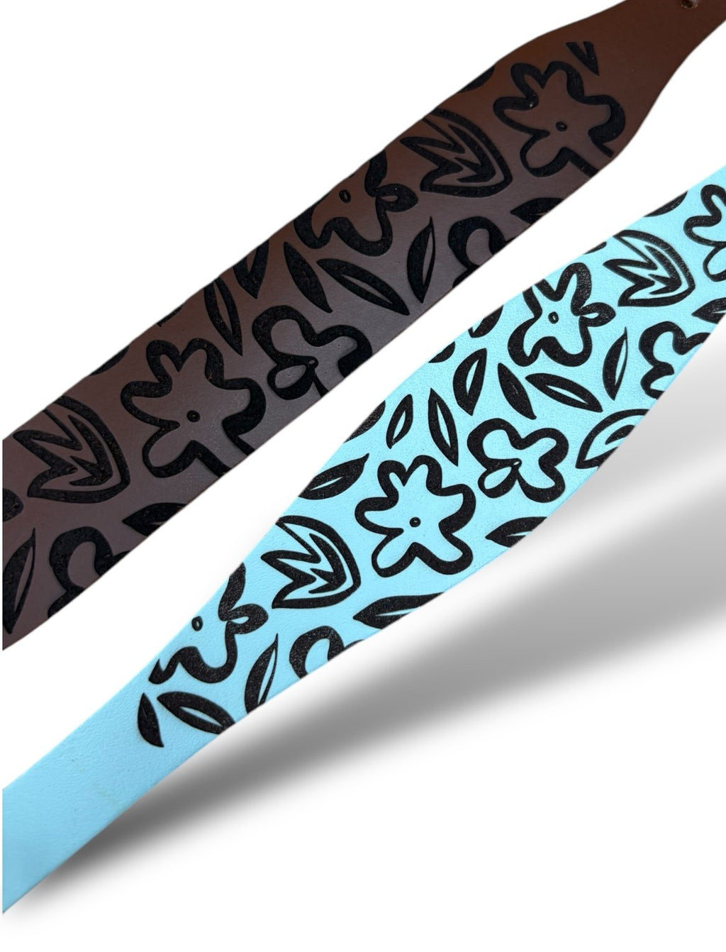 Two ribbons with floral patterns, one brown and one blue, on a white background.