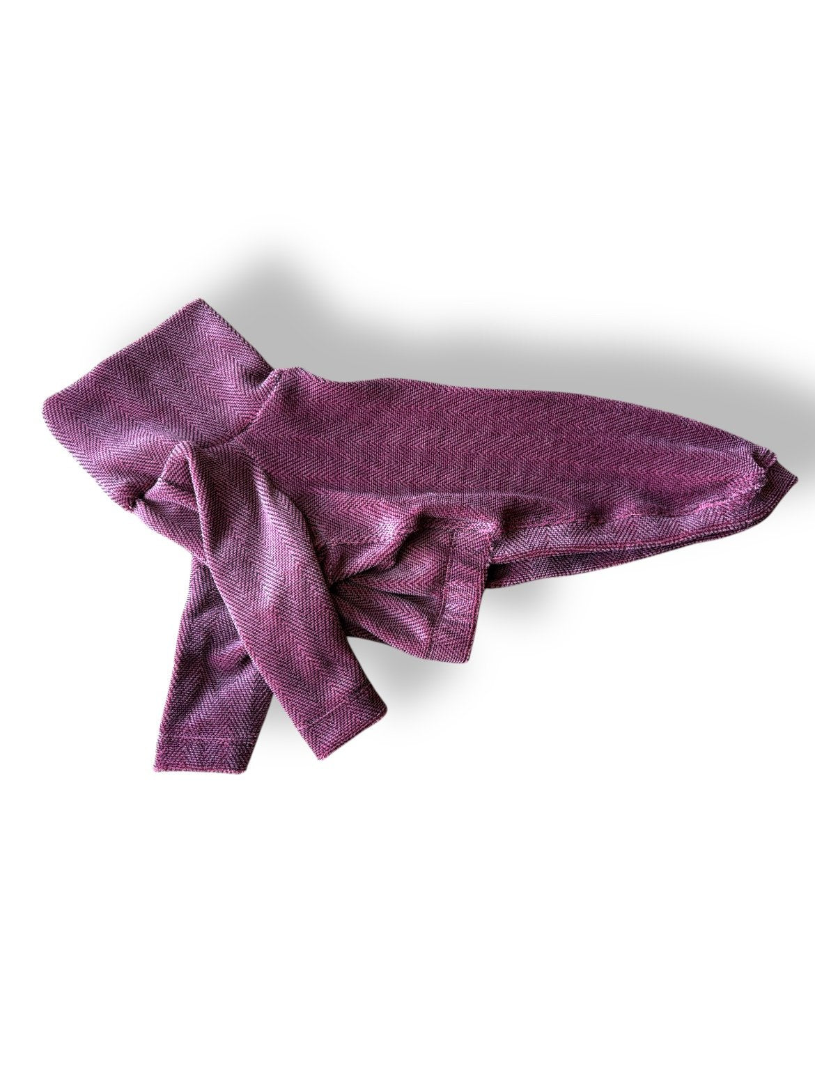 Purple knitted bow on a white background