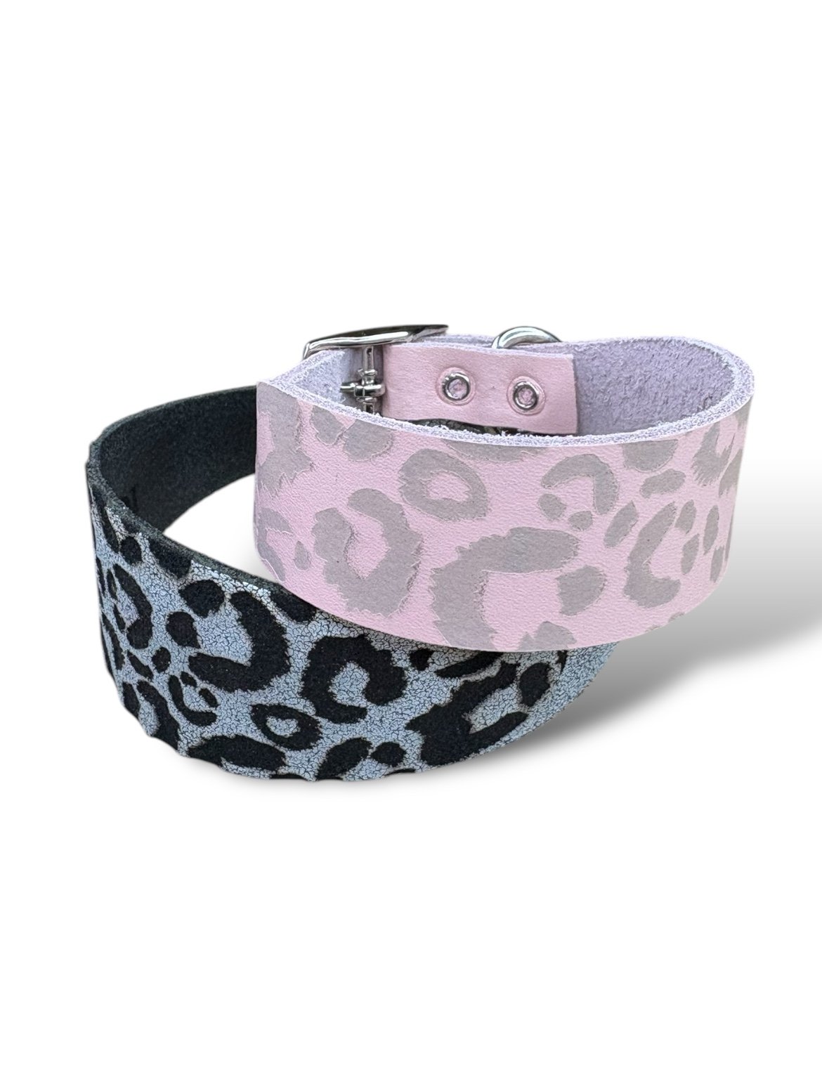 Two animal print dog collars, one pink and one black and gray, on a white background.