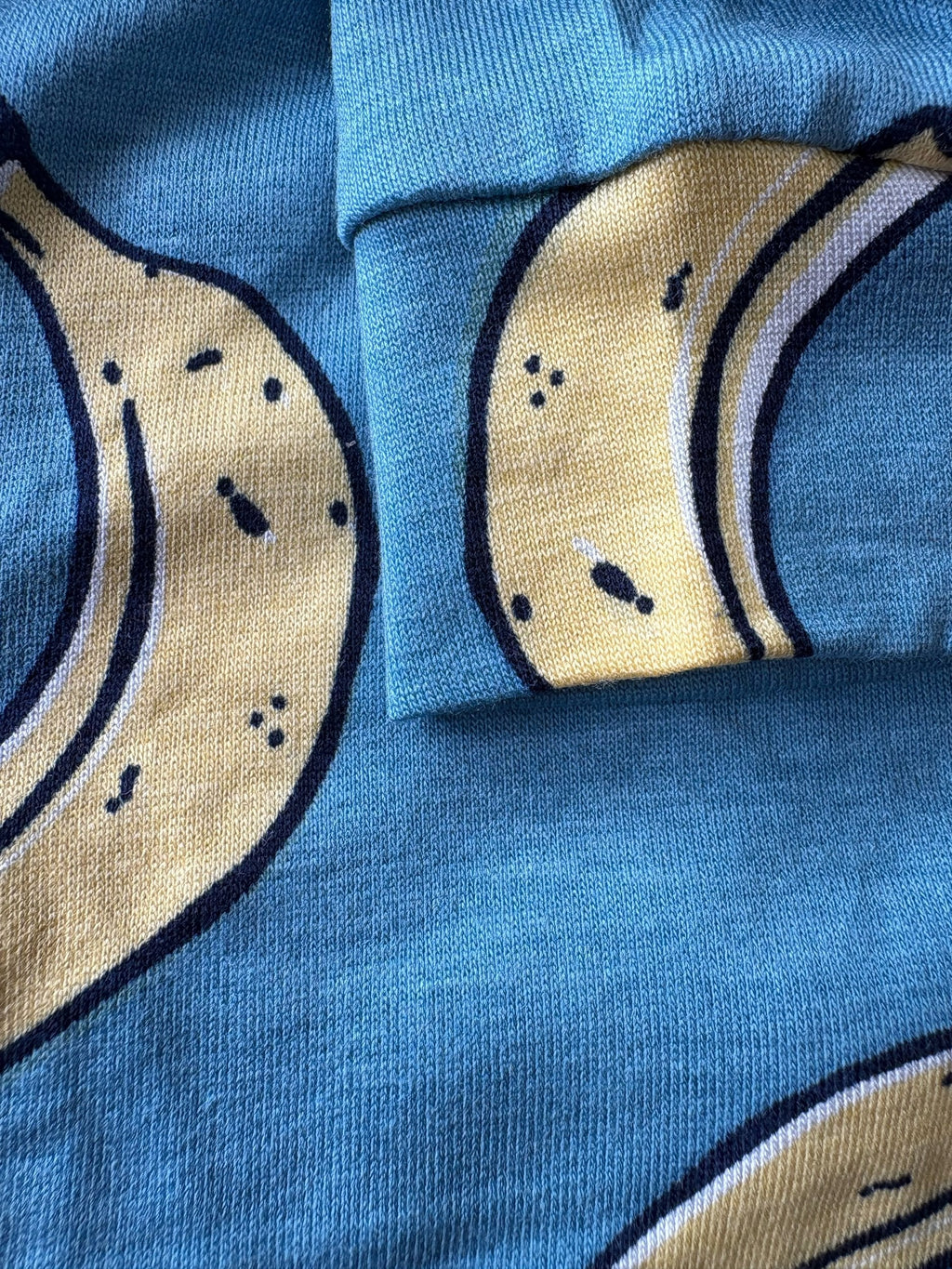 Close-up of blue fabric with beige crescent moon patterns