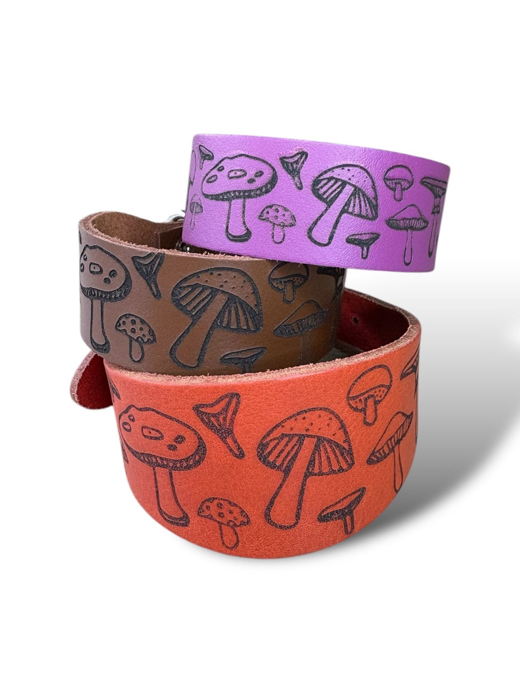 Three colorful bracelets with mushroom pattern on a white background