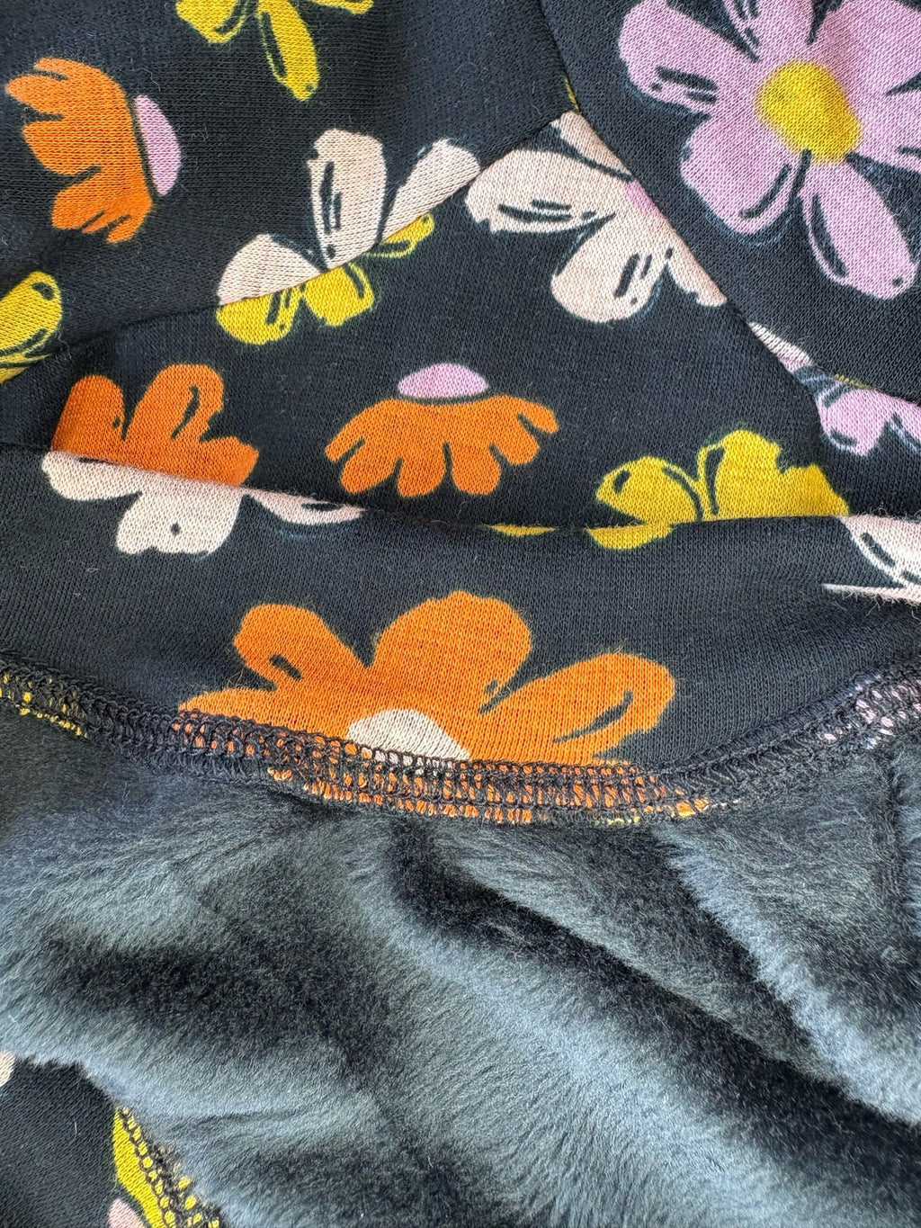 Close-up of a fabric with colorful floral patterns on a dark background