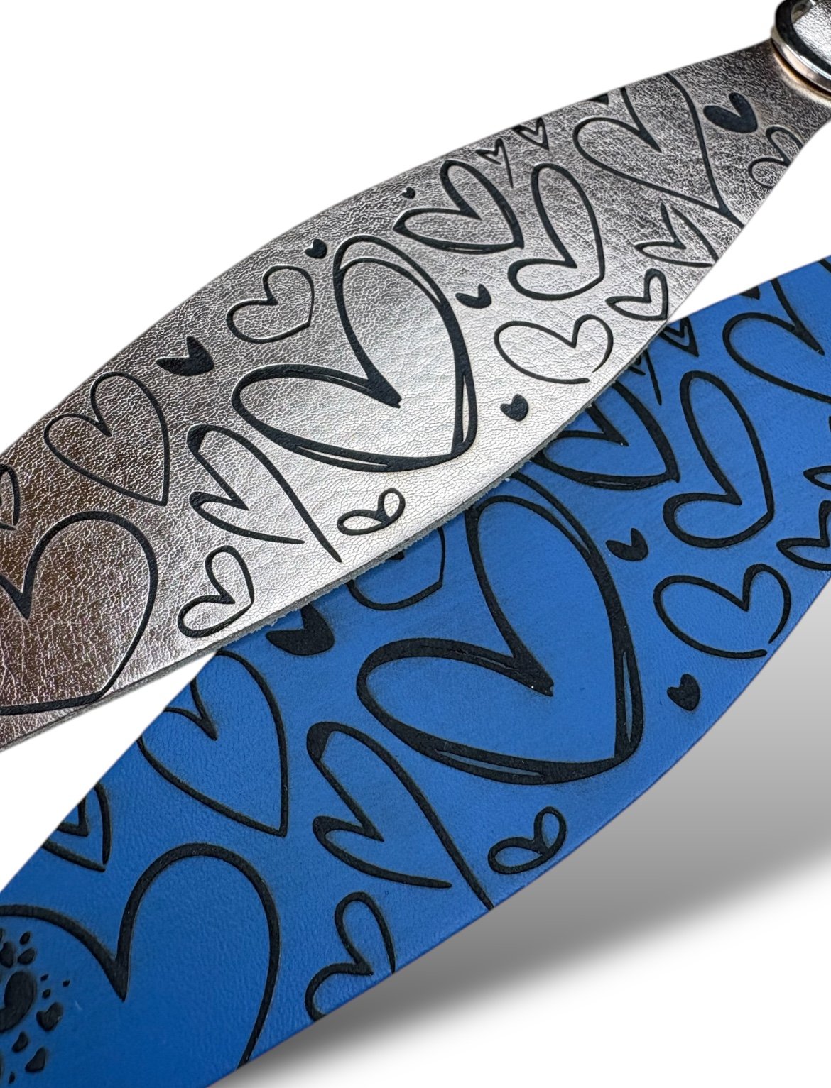 Close-up of a knife with heart patterns on a blue and silver background