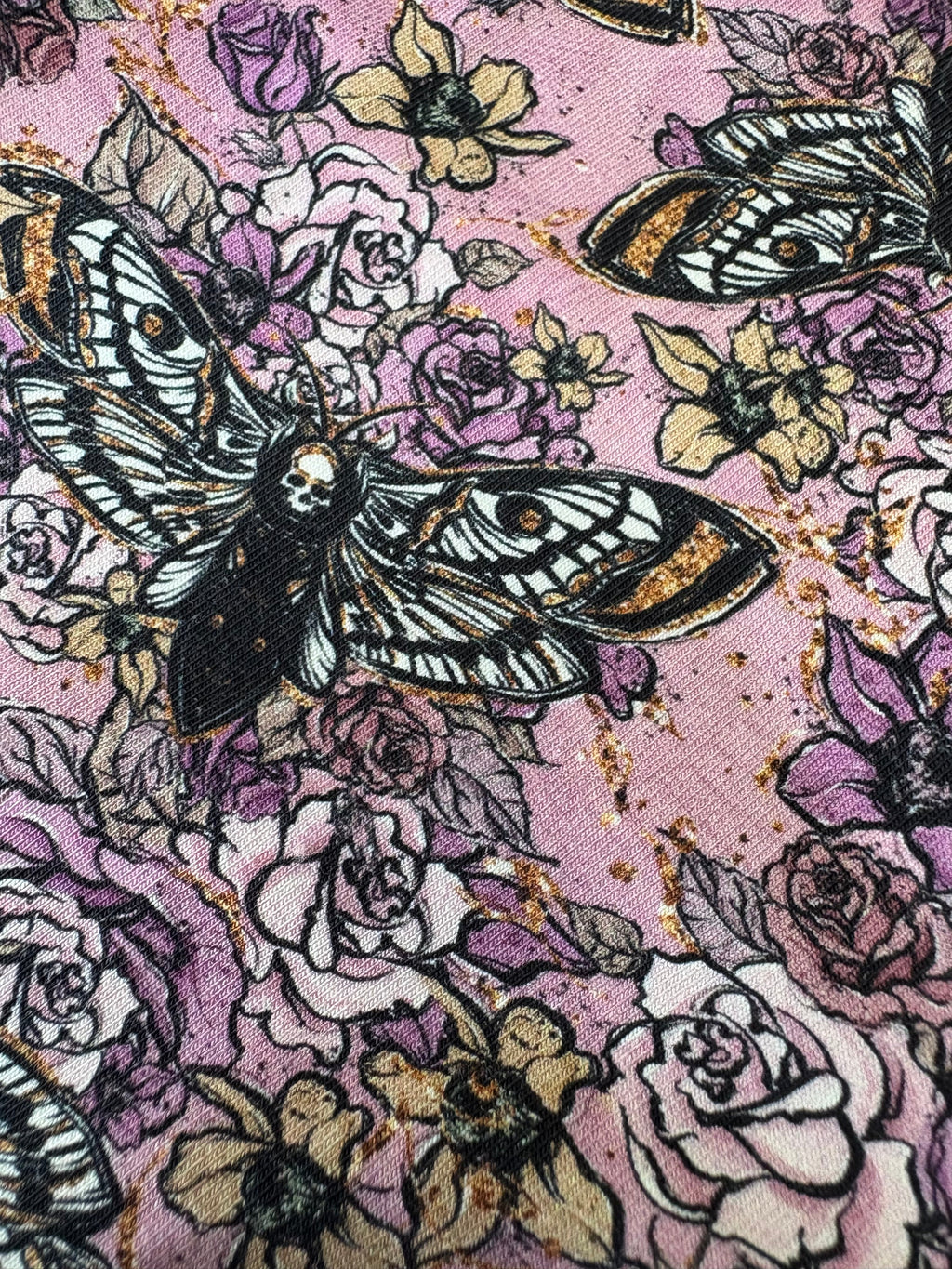 Pattern of butterflies and flowers on a pink background