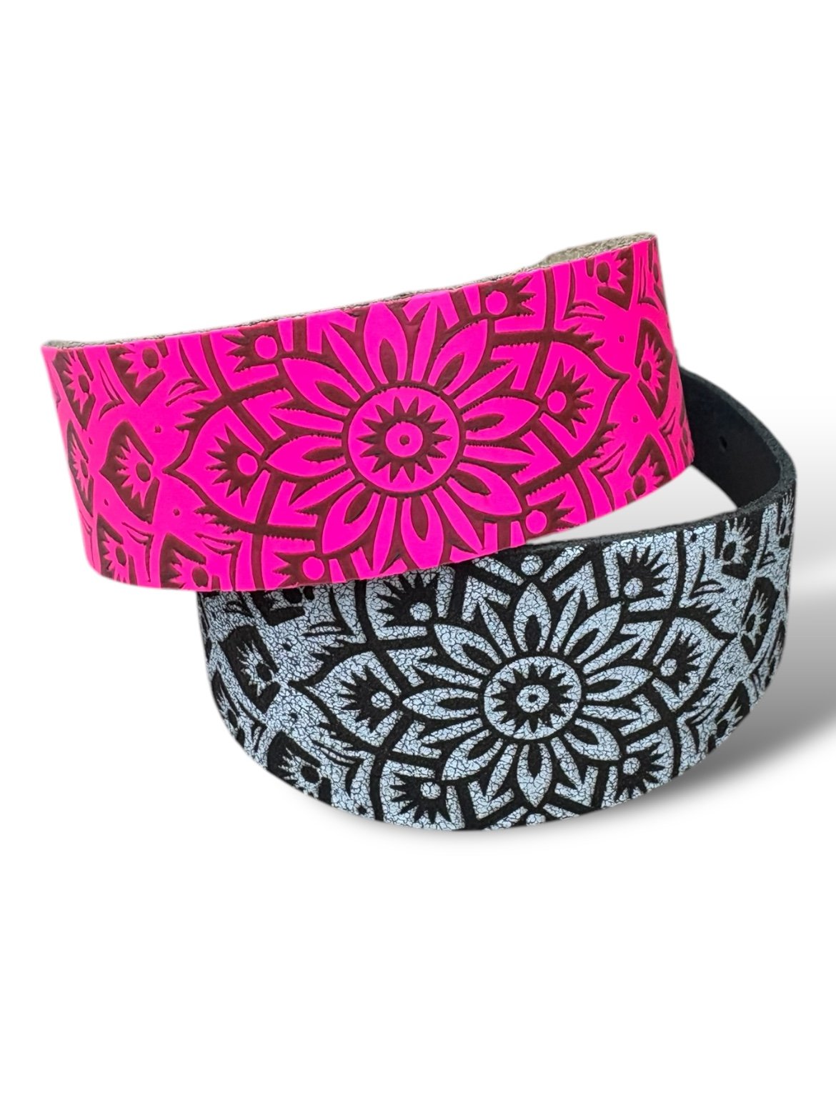 Two headbands with floral patterns, one pink and one black and white, on a white background.