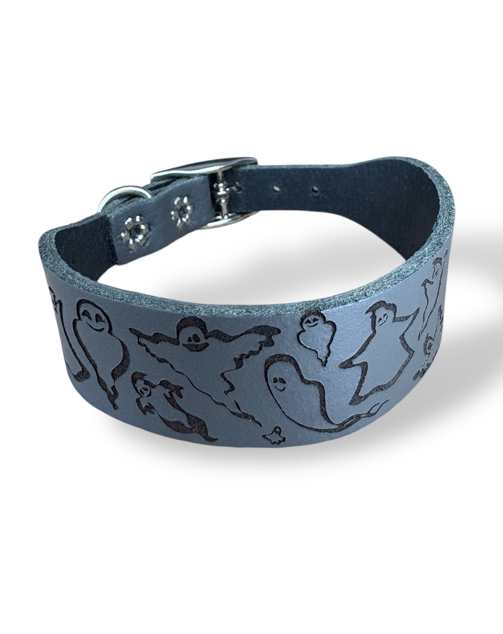 Blue leather dog collar with black engraved designs on a white background