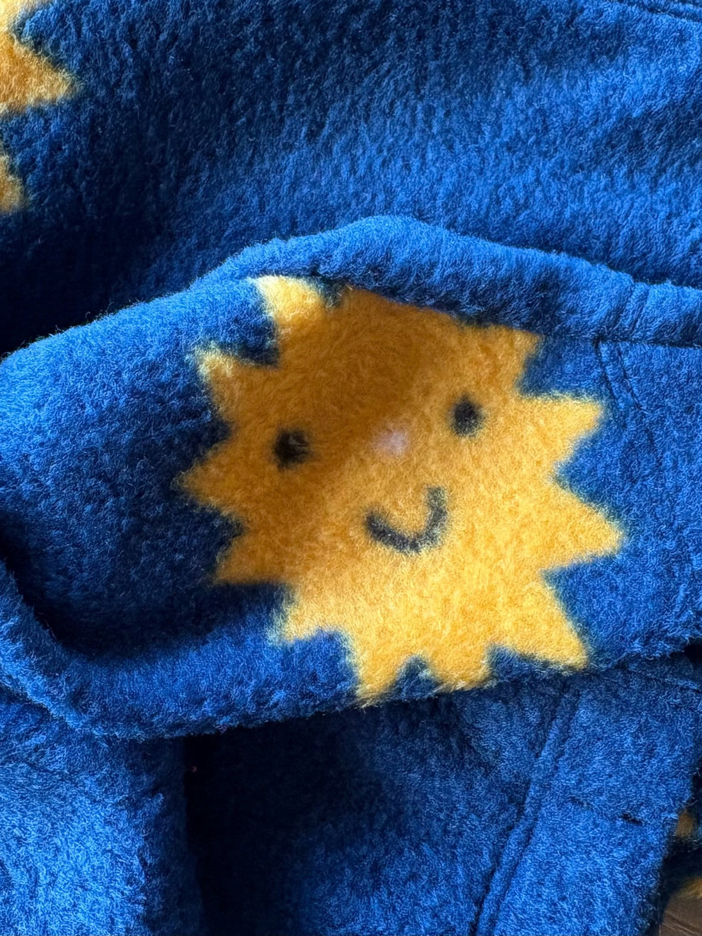 Blue fabric with a yellow sun design