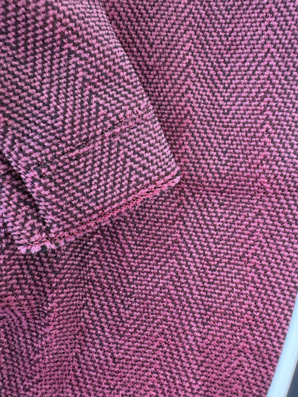 Close-up of pink fabric with a herringbone pattern
