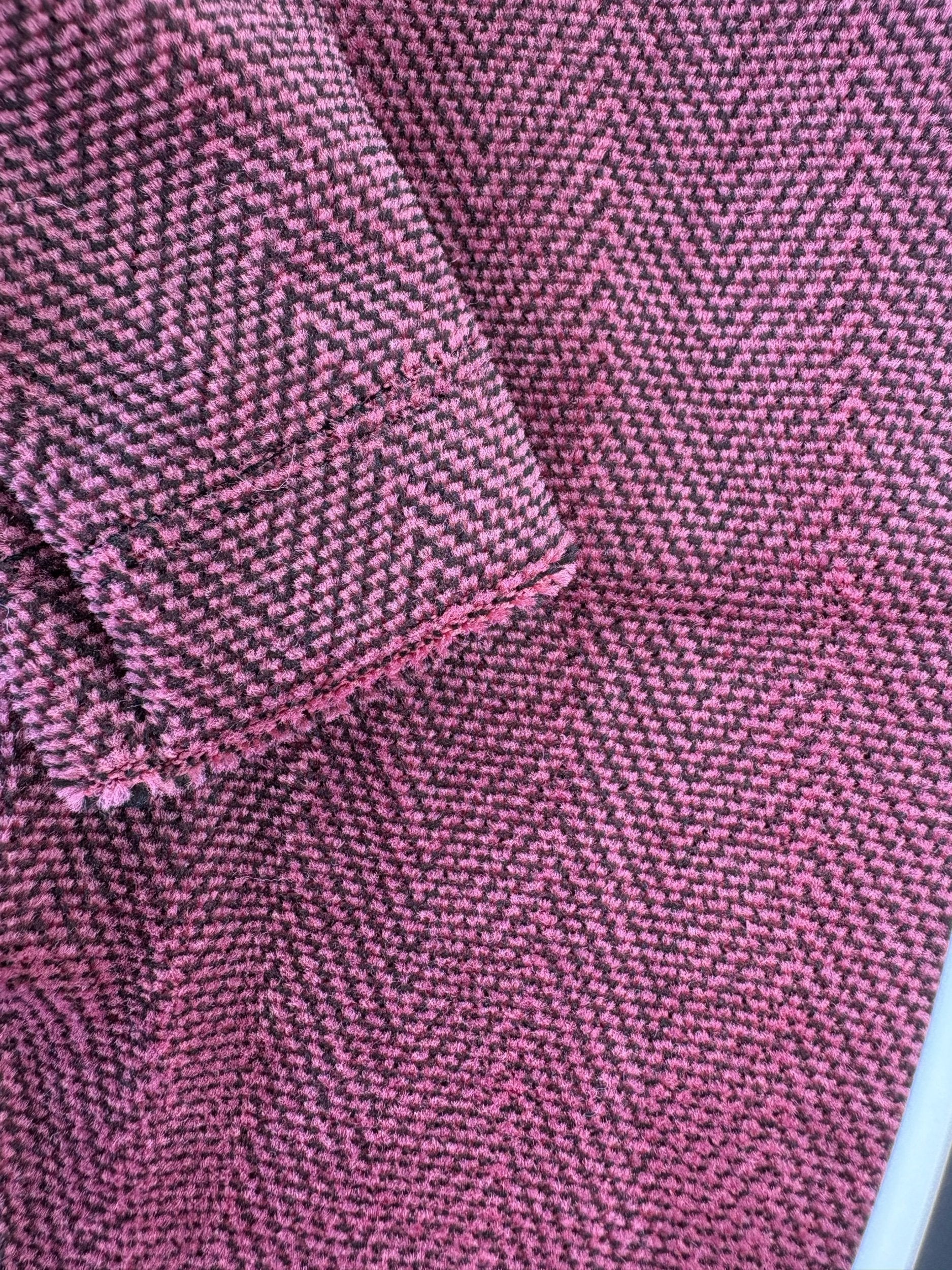 Close-up of pink fabric with a herringbone pattern