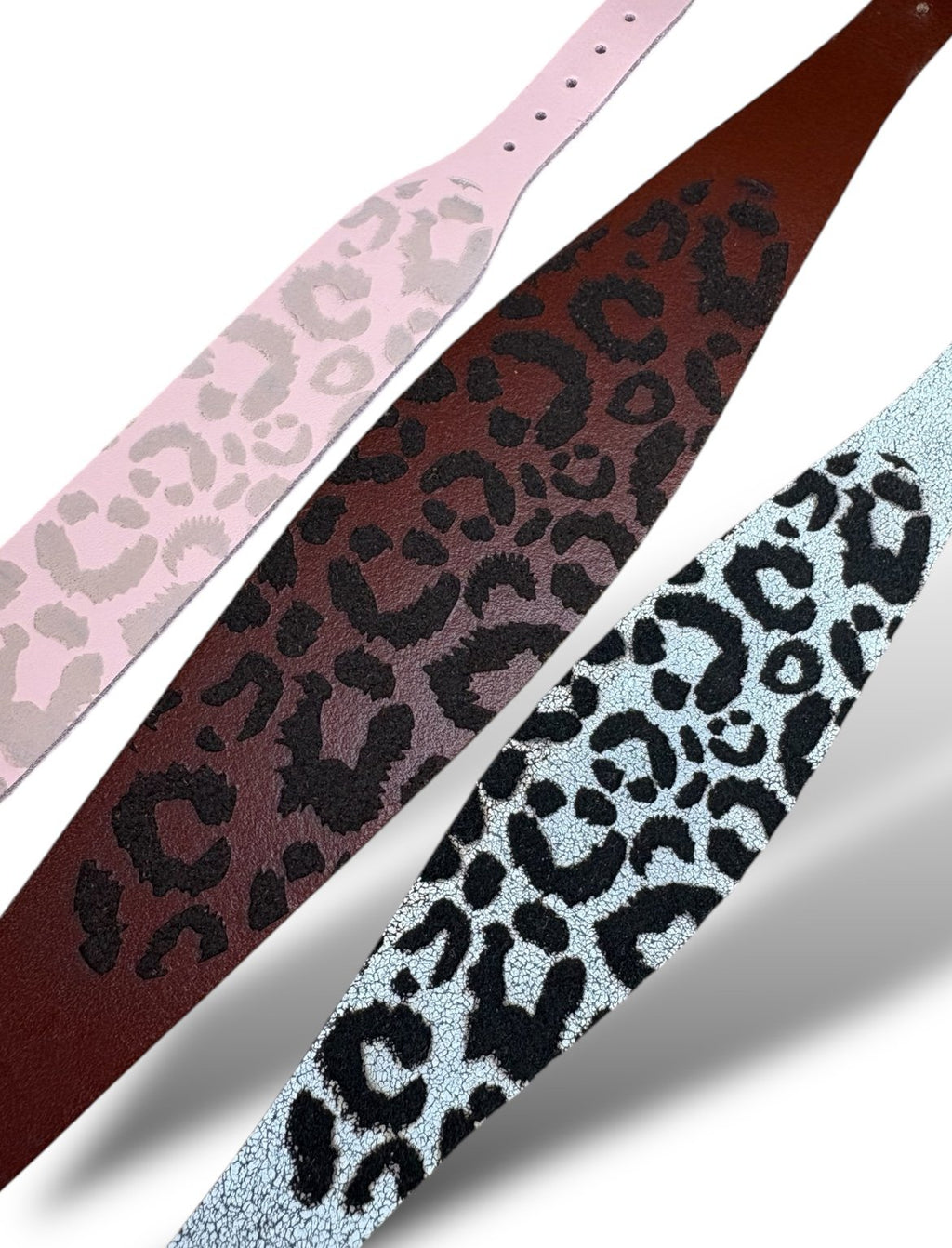 Leopard print straps in pink, brown, and light blue on a white background