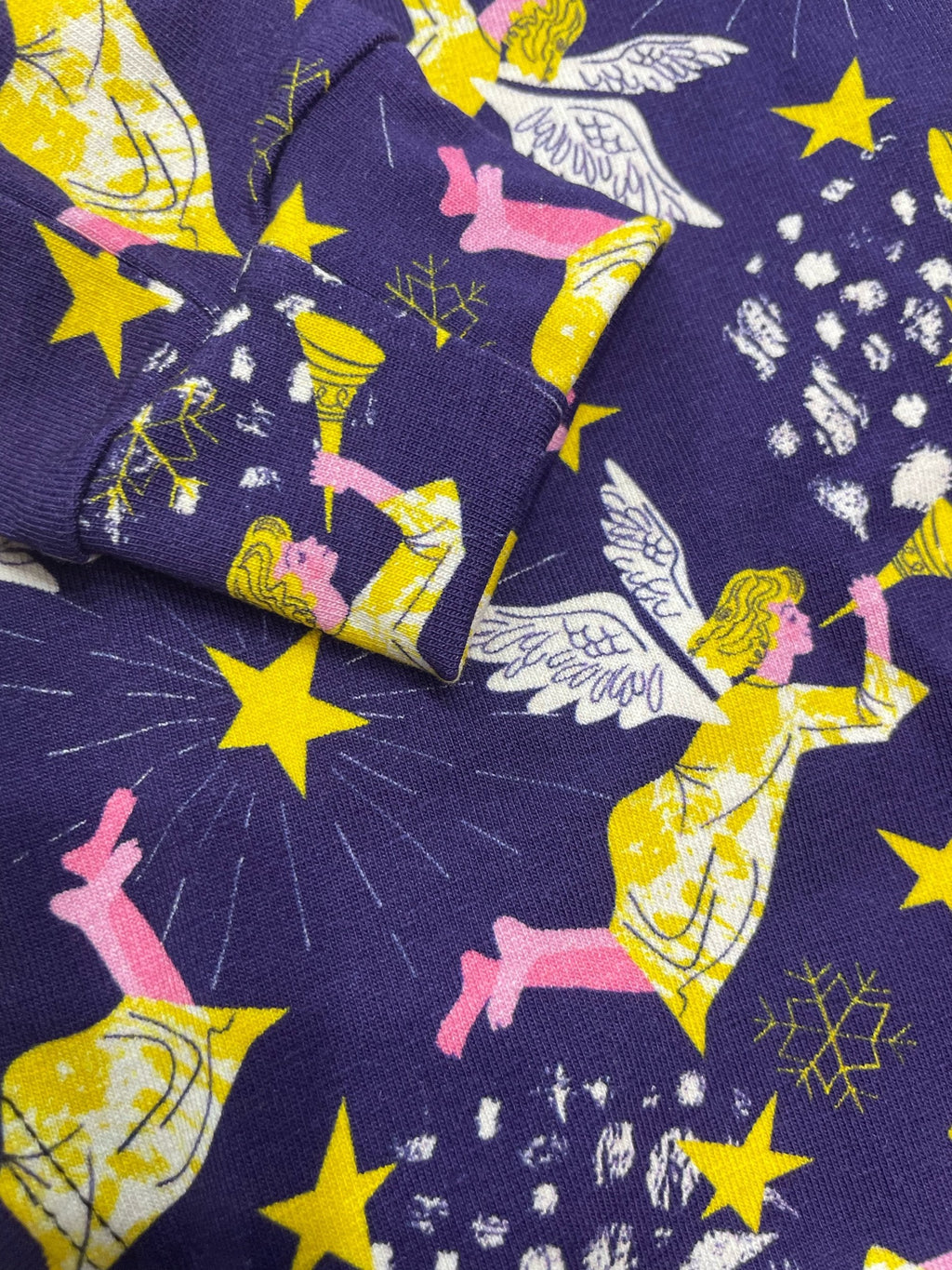 Socks with angel and star pattern on a purple background