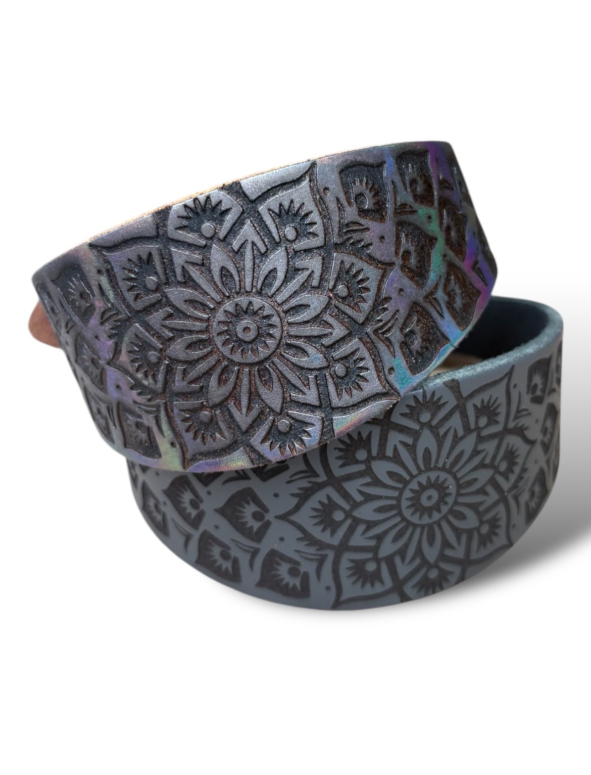 Black and gray patterned belt with a mandala design on a white background
