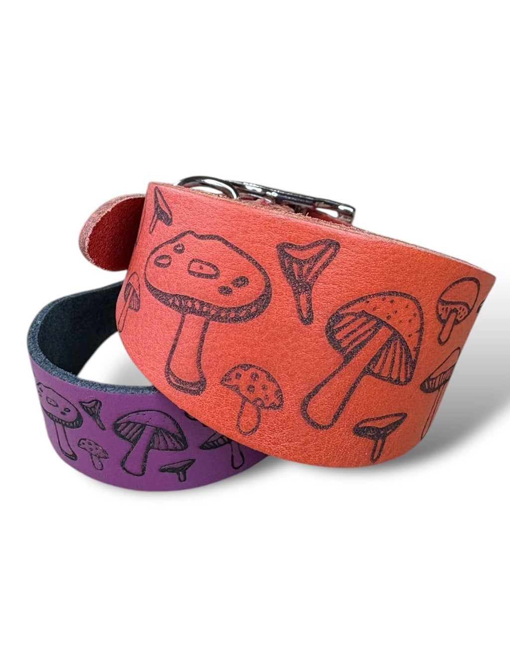Two leather straps with mushroom pattern on a white background