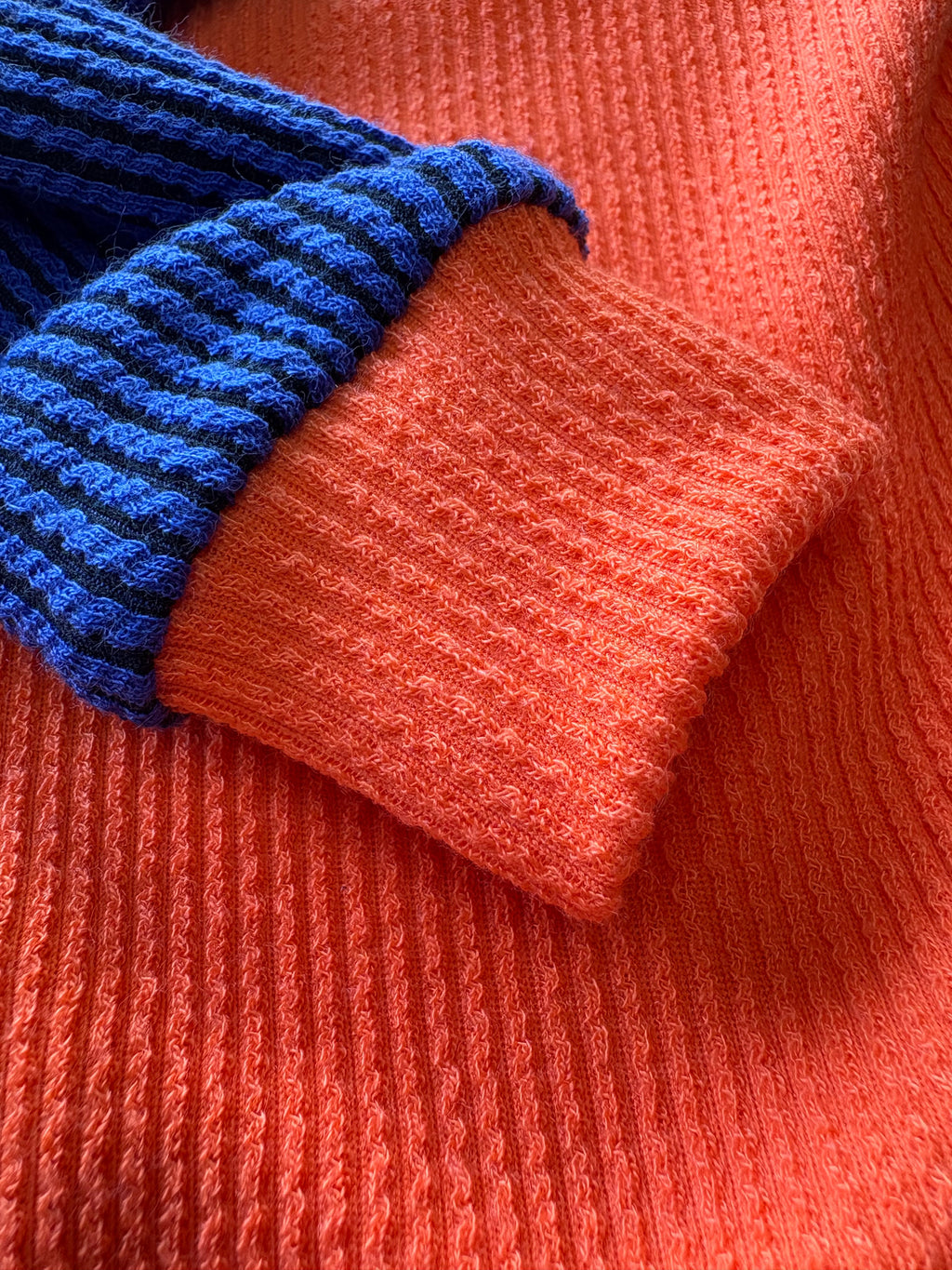 Close-up of a blue and orange knitted fabric