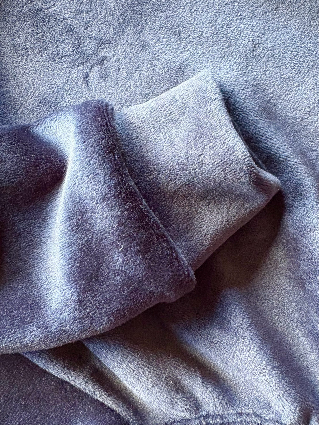 Close-up of textured gray fabric with folds