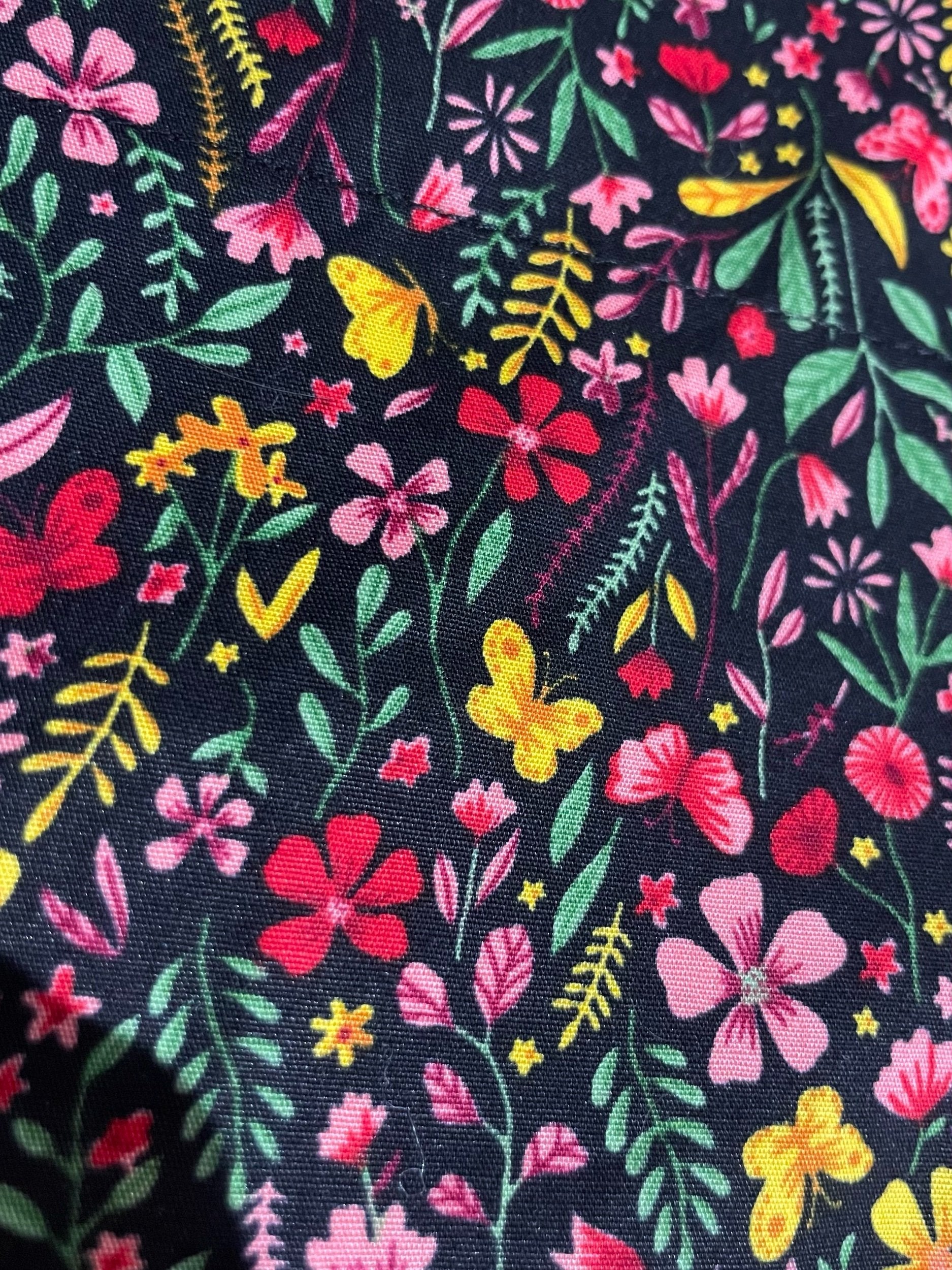 Colorful floral and butterfly pattern on a dark background