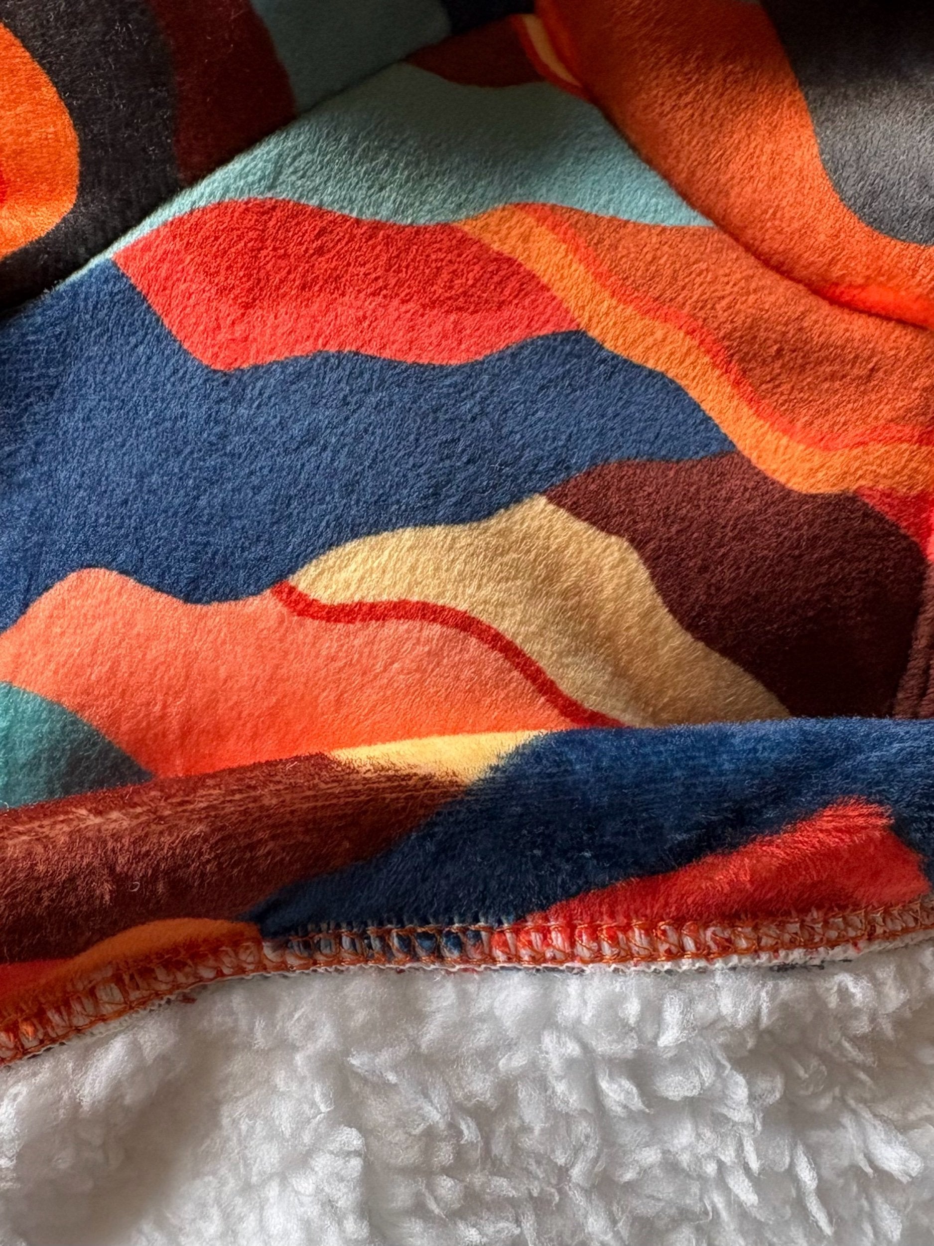 Close-up of a colorful fabric with abstract patterns on a white background