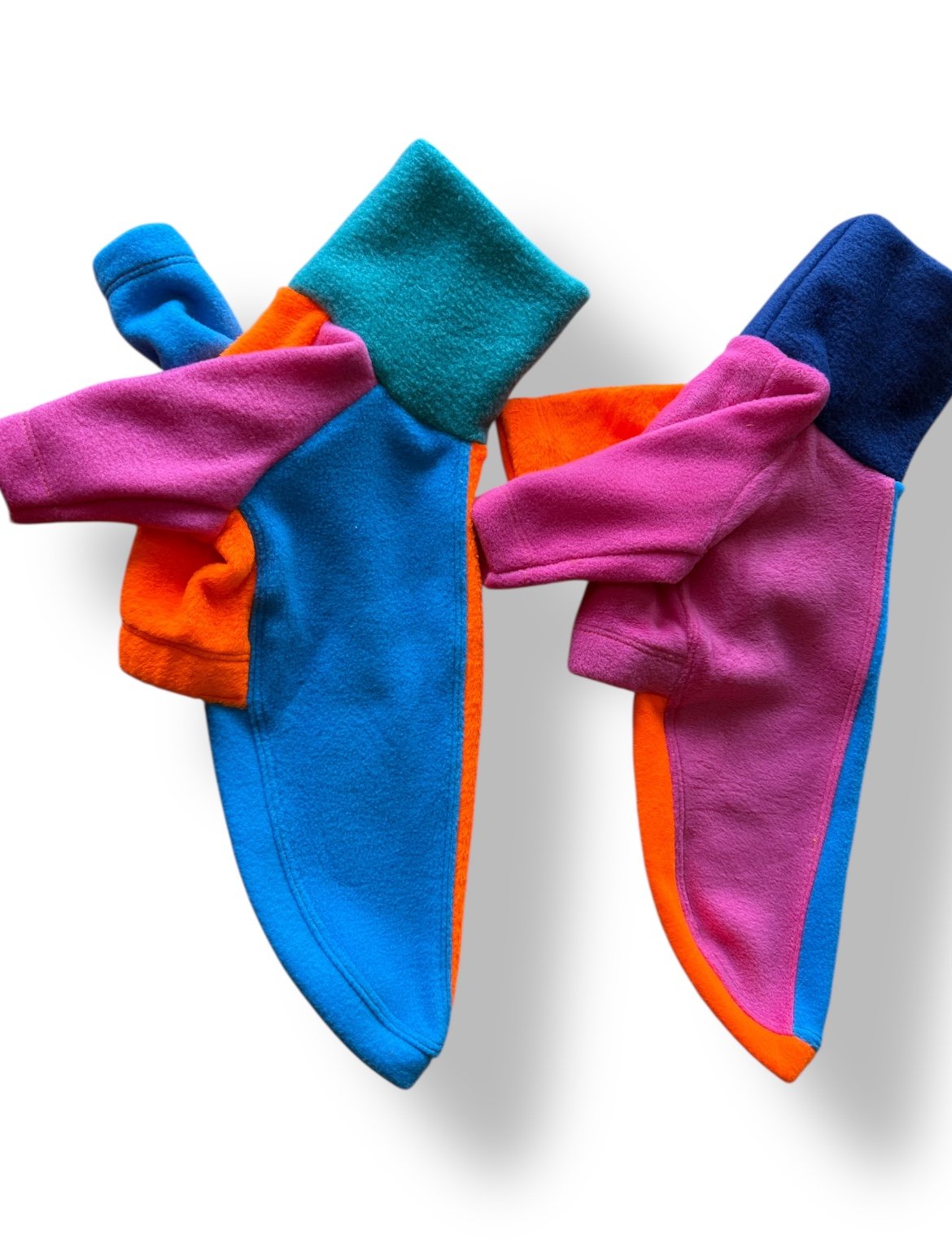 Colorful socks with blue, pink, and orange patterns on a white background