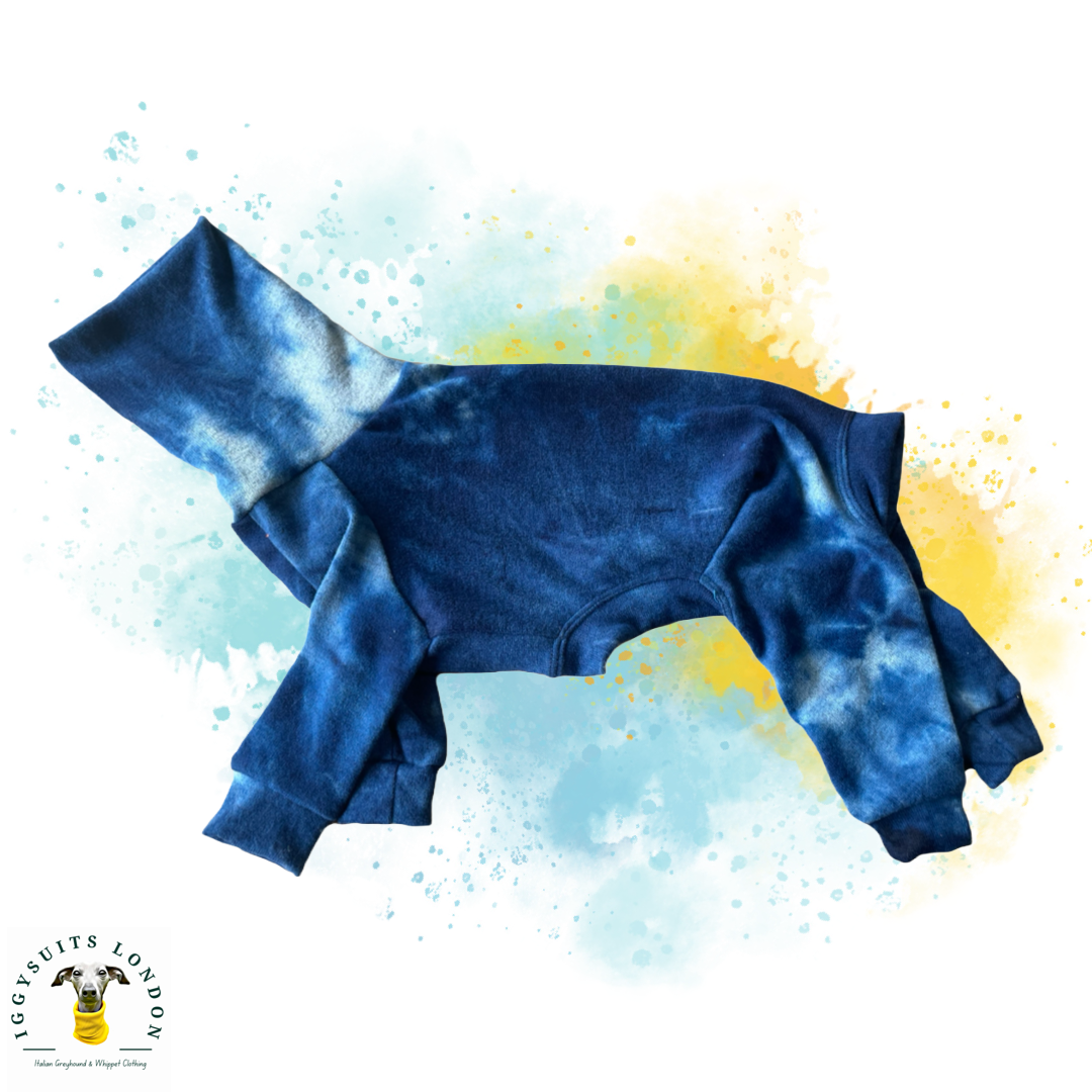 Blue tie-dye baby romper on a colorful abstract background