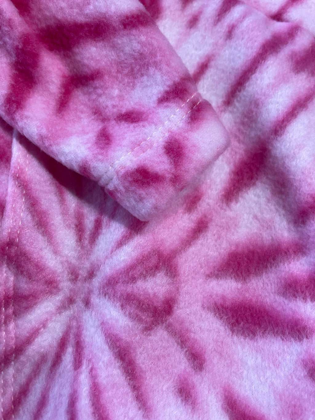 Close-up of pink textured fabric with a swirling pattern