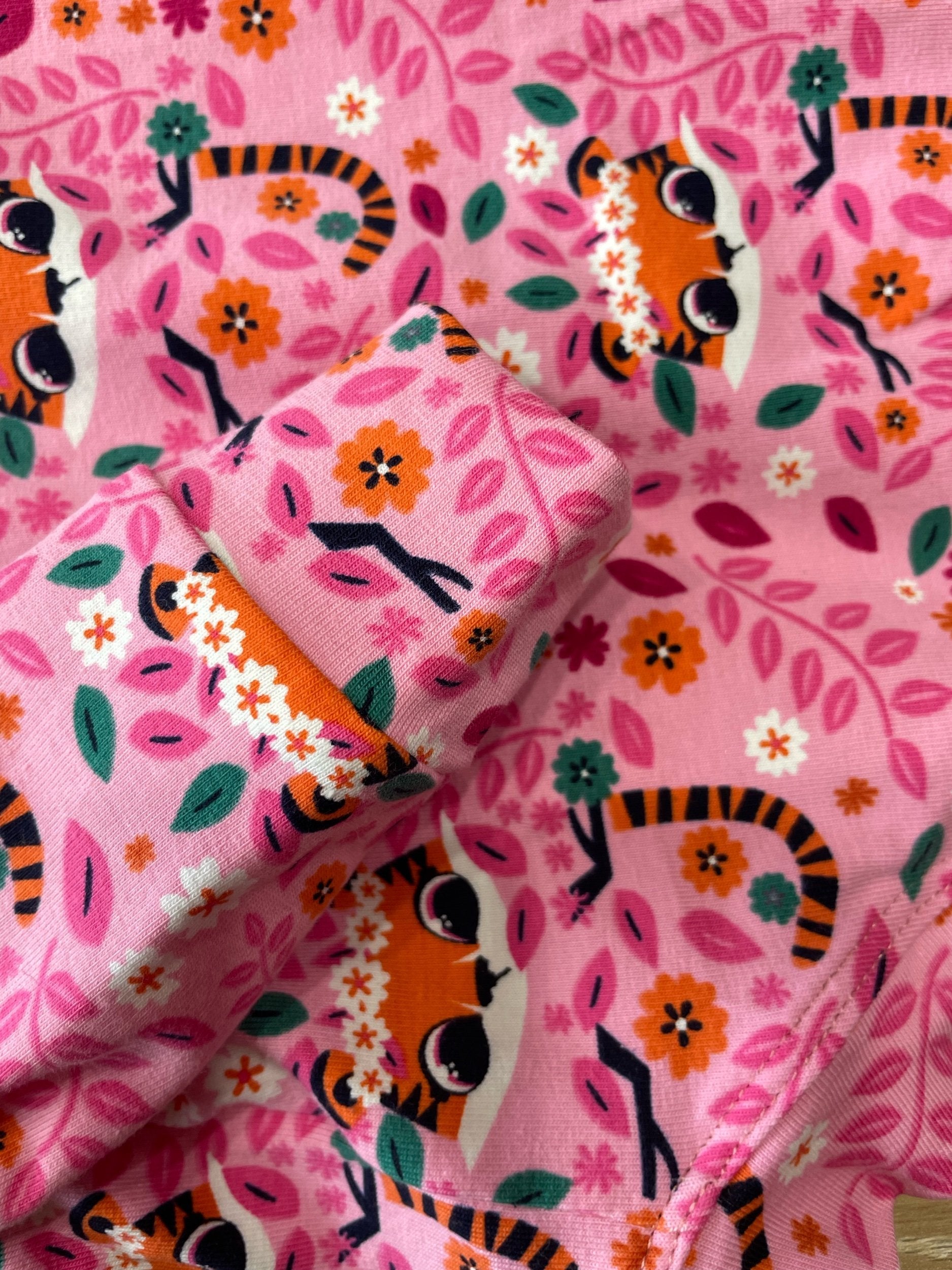 Pink fabric with tiger and floral pattern