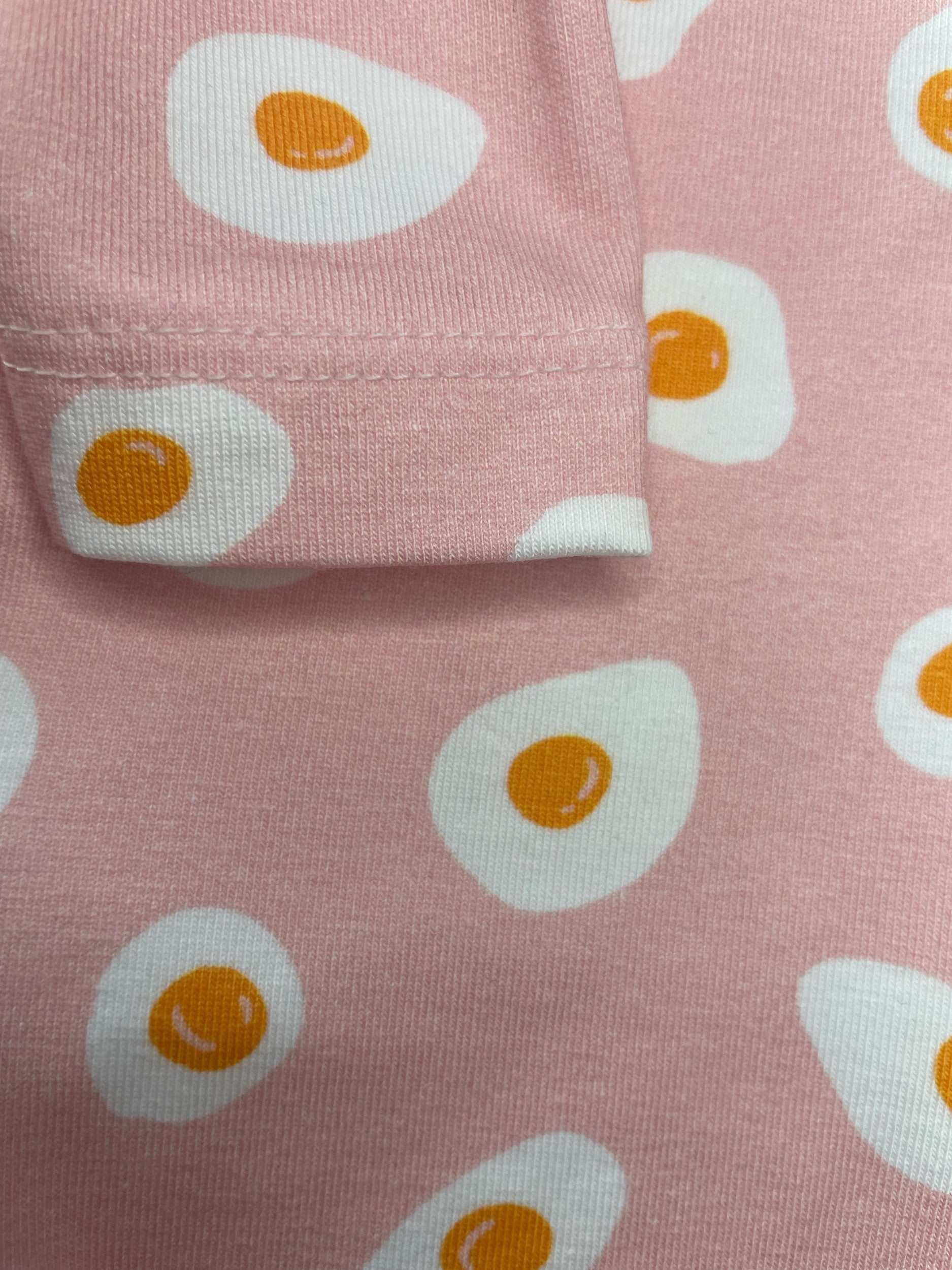 Pink fabric with white eggs pattern