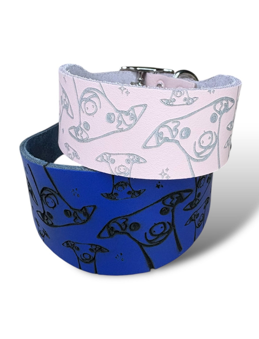 Two patterned dog collars, one blue and one pink with white designs, on a white background.