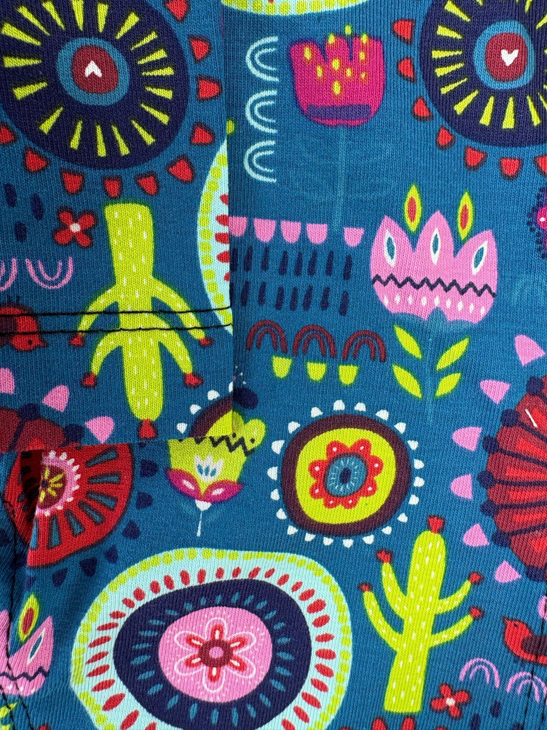 Colorful fabric pattern with abstract designs on a blue background