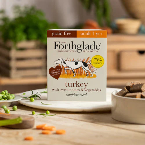 Forthglade dog food package on a table with food items in the background