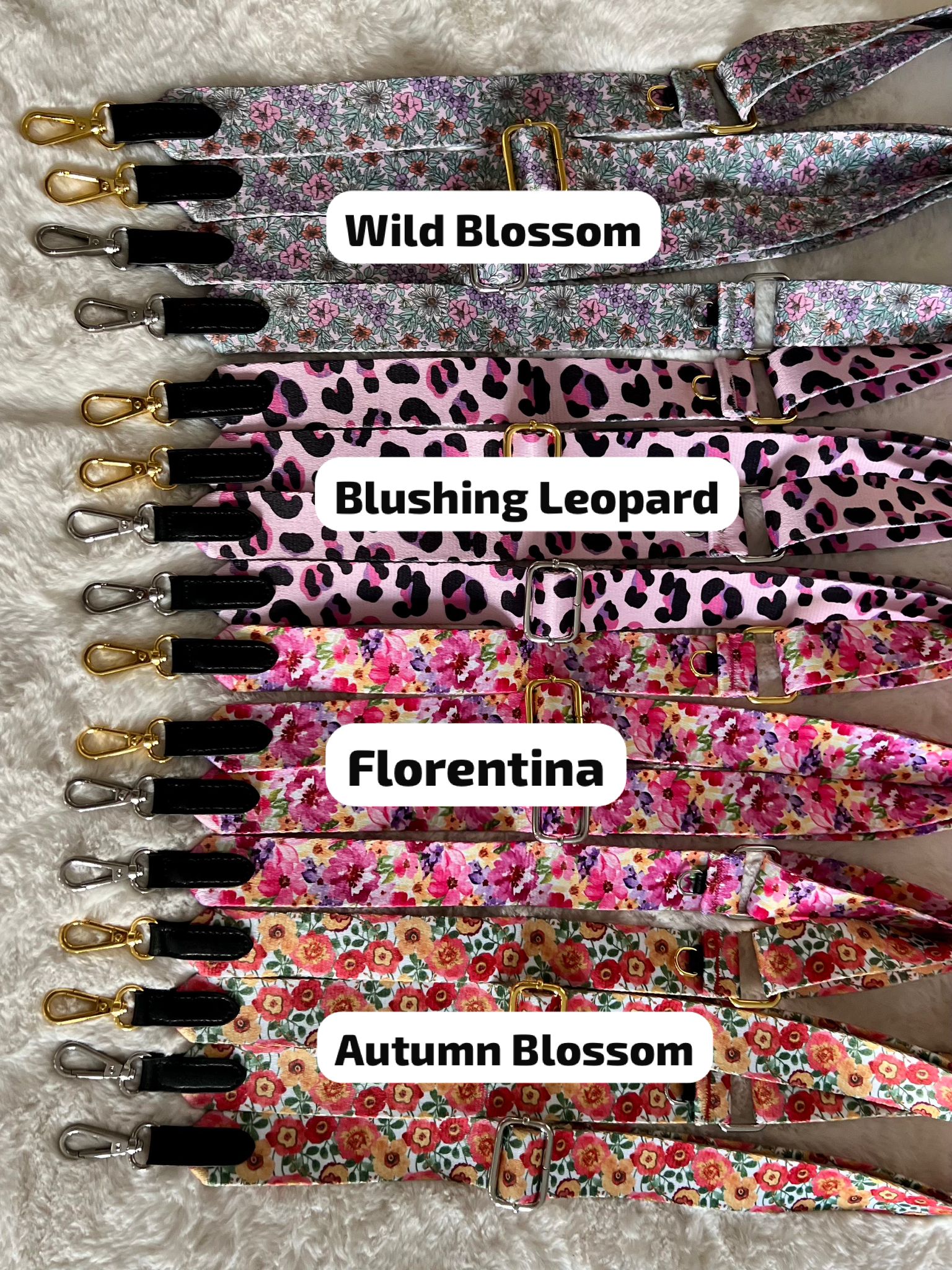 Set of floral lanyards with different patterns labeled 'Wild Blossom', 'Blushing Leopard', 'Florentina', and 'Autumn Blossom' on a textured surface.
