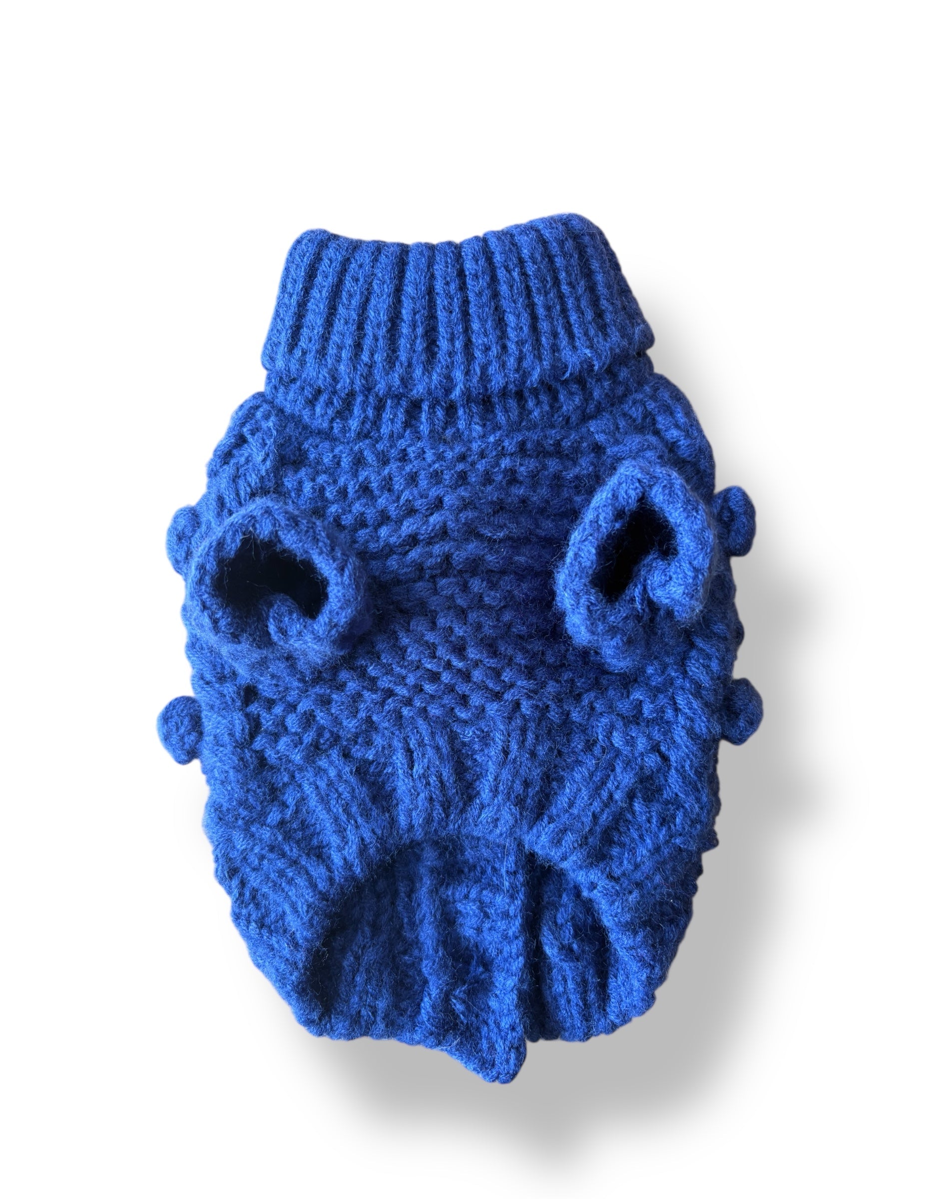Blue knitted dog sweater on a white background