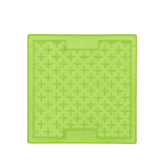 Green manhole cover with a grid pattern on a white background