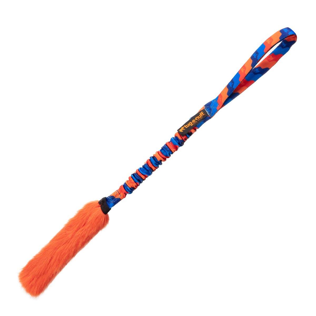 The Bright Fauxtastic Tug is a colorful interactive dog toy with a blue and orange patterned handle, an orange faux fur tail, and a looped grip—ideal for tug games or recall training.