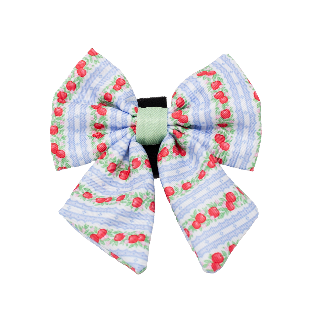 Large decorative bow with cherry pattern on a white background