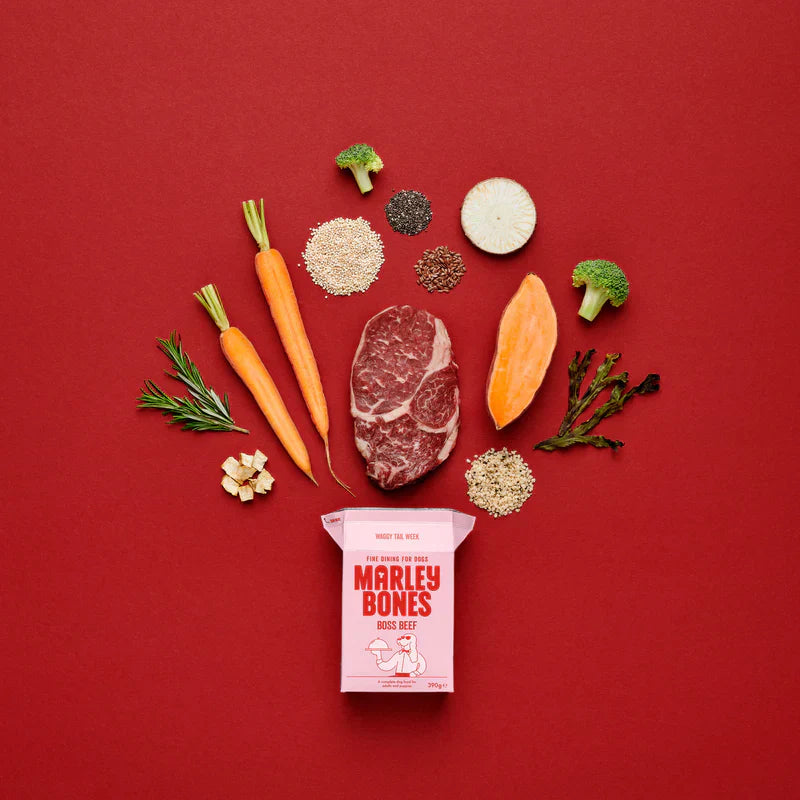 Raw meat with vegetables and a package of Marley Bones on a red background