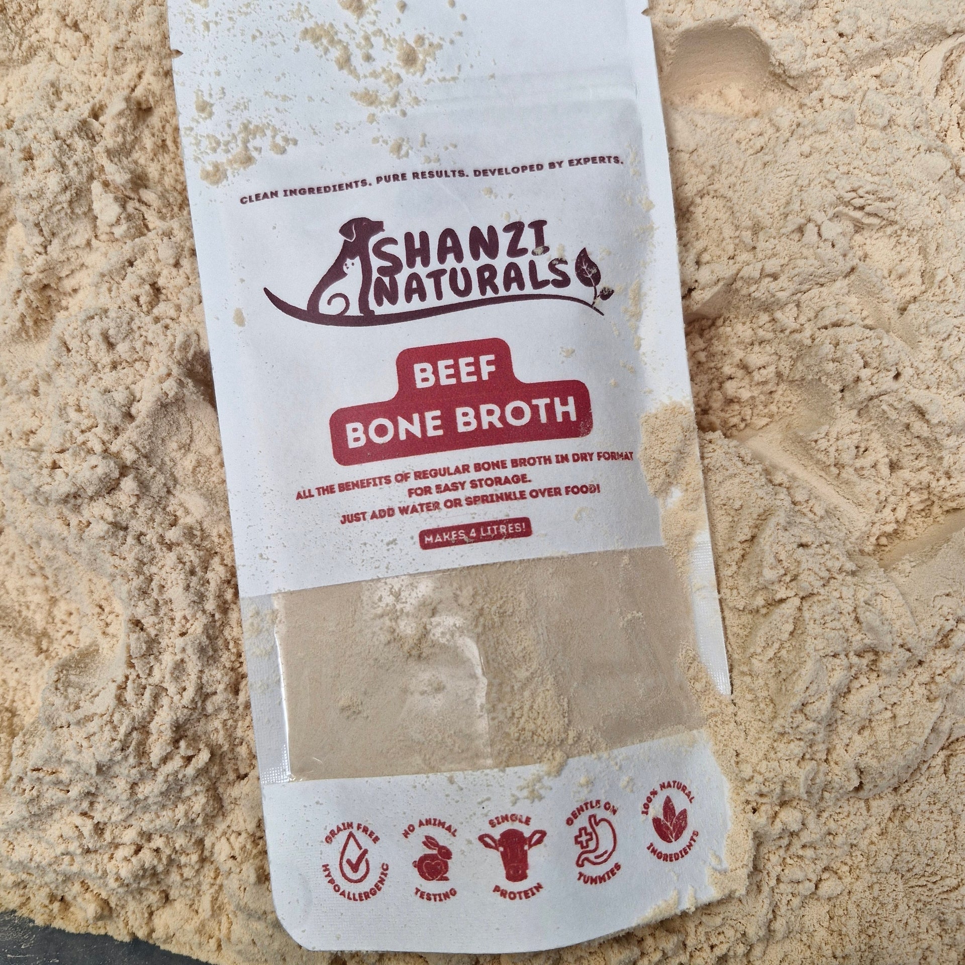 Shanzi Naturals Beef Bone Broth package on a sandy background